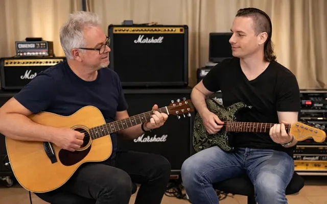 Privé gitaarles voor Hasselt met Wouter Baustein en een student met rode elektrische gitaar